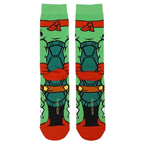 Green and orange socks with cartoon turtle design.