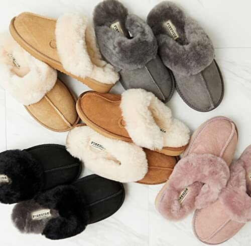 Various fur-lined slippers in different colors on a white surface.