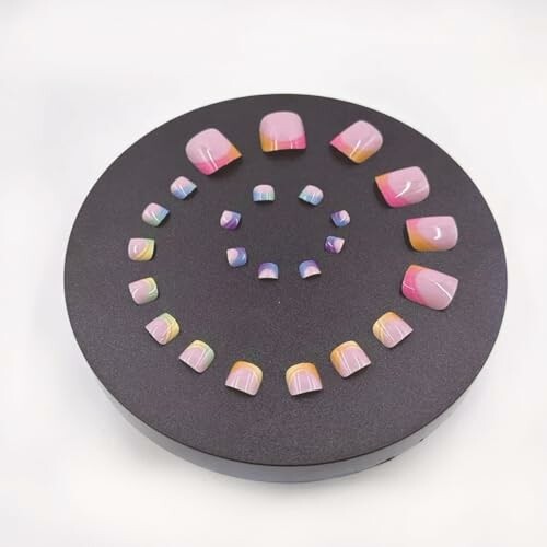 Display of gradient fake nails arranged in a circle.