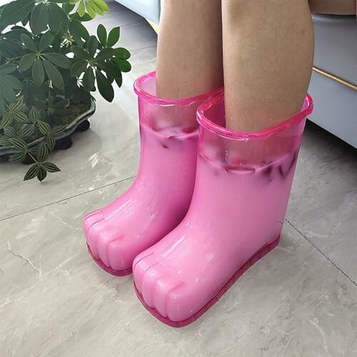 Person wearing pink toe-shaped boots filled with liquid.