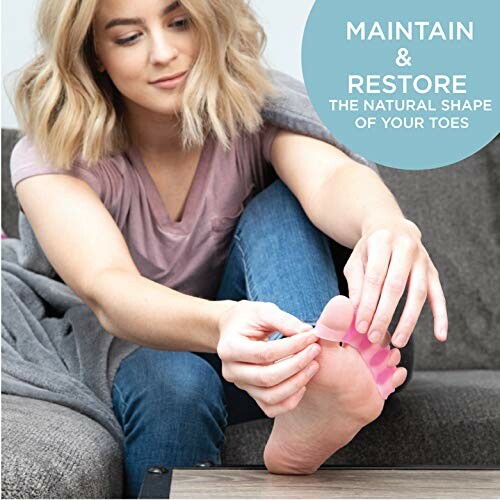 Person adjusting toes with a toe separator on a couch.