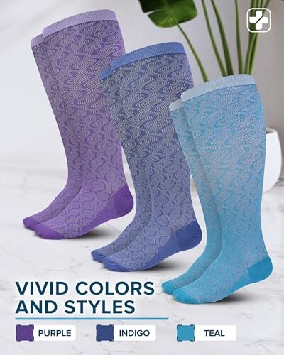 Three pairs of socks in purple, indigo, and teal with vivid patterns.