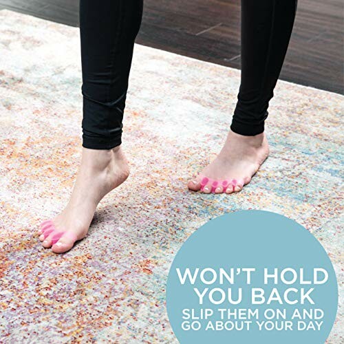 Person wearing pink toe separators on a rug.